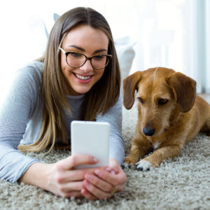Woman and dog looking at a phone
